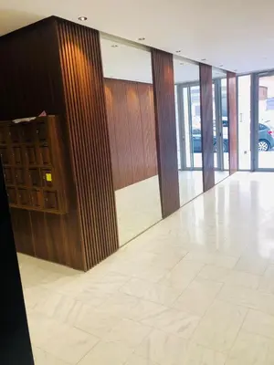 a lobby with glass doors and a tile floor at Lux, comfy and cosy Apartment in Casablanca