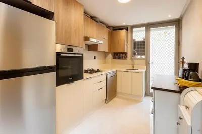 a kitchen with white cabinets and a stove top oven at Lux, comfy and cosy Apartment in Casablanca
