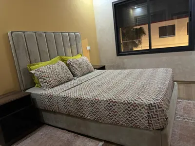 a bed in a small room with a bed sidx sidx sidx at App à côté du parc et corniche in Mohammedia