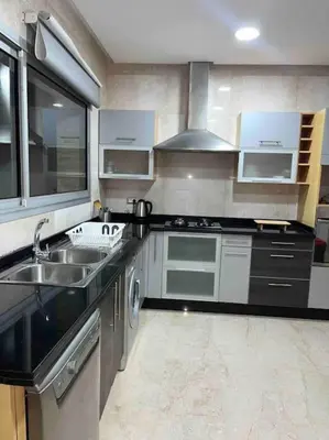 a kitchen with a sink and a stove top oven at Luxury Villa Oasis, Bouznika Bay in Bouznika