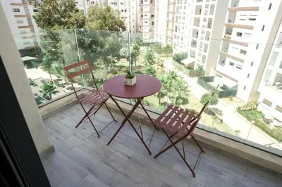 a table and two chairs sitting on a balcony at Luxury Prestigia 2Bed Rooms in Rabat