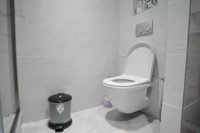 a bathroom with a toilet and a trash can at Luxury Prestigia 2Bed Rooms in Rabat