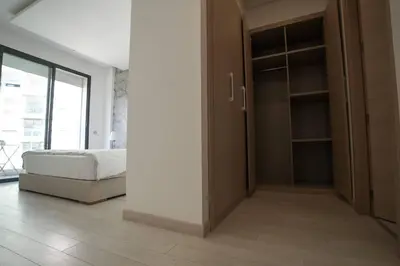 a bedroom with a closet with a bed in it at Luxury Prestigia 2Bed Rooms in Rabat