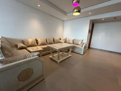 a living room with a couch and a table at Appartement Ocean View - Marina Casablanca in Casablanca