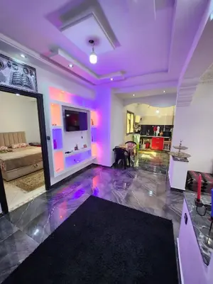 a living room with purple lights on the floor at chez Jalil in Aïn ej Jmel