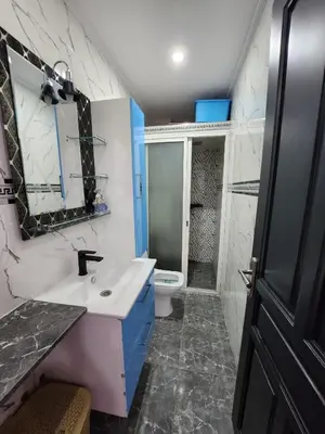 a bathroom with a sink and a toilet at chez Jalil in Aïn ej Jmel