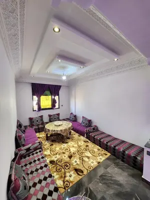 a living room with a couch and a table at chez Jalil in Aïn ej Jmel