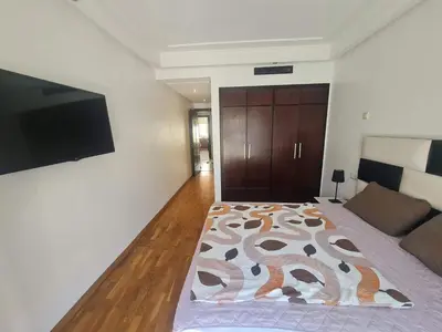 a bedroom with a bed and a flat screen tv at Horizon Appartement Playa in Casablanca