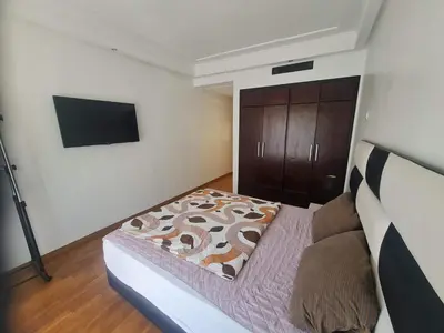 a bedroom with a bed and a flat screen tv at Horizon Appartement Playa in Casablanca