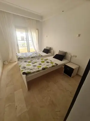 a bedroom with two beds and a window at Horizon Appartement Playa in Casablanca