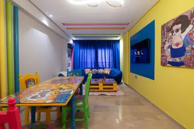 a dining room with a table and a couch at Pop Art Studio-Location Journalière Casablanca in Casablanca