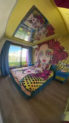 a bedroom with a bed with a painting on the wall at Pop Art Studio-Location Journalière Casablanca in Casablanca