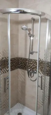 a shower with a glass door in a bathroom at APPARTEMENT haut standing in O Ben Slimane