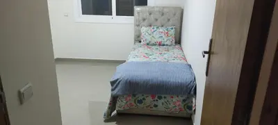 a small bed in a room next to a window at APPARTEMENT haut standing in O Ben Slimane