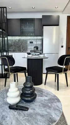a kitchen with a table and some chairs and a counter at Top Floor Studio - By AppartAli in Casablanca