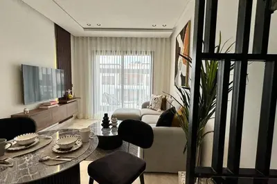 a living room with a couch and a table at Top Floor Studio - By AppartAli in Casablanca