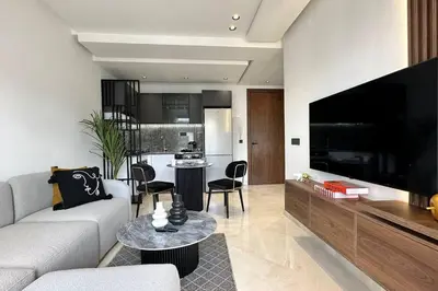 a living room with a couch and a large television at Top Floor Studio - By AppartAli in Casablanca