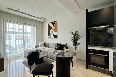 a living room with a couch and a tv at Top Floor Studio - By AppartAli in Casablanca