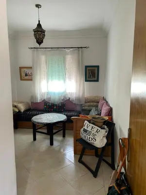 a living room with a couch and a table at Apparemment déjà vendu ne réserve pas in Azemmour