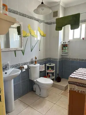 a bathroom with a toilet and a sink at Apparemment déjà vendu ne réserve pas in Azemmour
