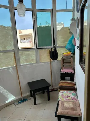 a room with two chairs and a table and windows at Apparemment déjà vendu ne réserve pas in Azemmour