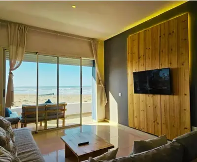 a living room with a couch and a table at Sidi Rahal Blue View, Beachfront wide seaview with pool in Sidi Rahal
