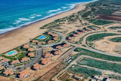 an aerial view of a beach with houses and the ocean at Sidi Rahal Blue View, Beachfront wide seaview with pool in Sidi Rahal