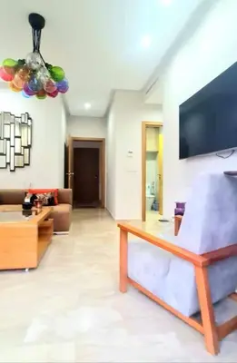 a living room with a couch and a tv at Appartement Casablanca in Dar Bouazza