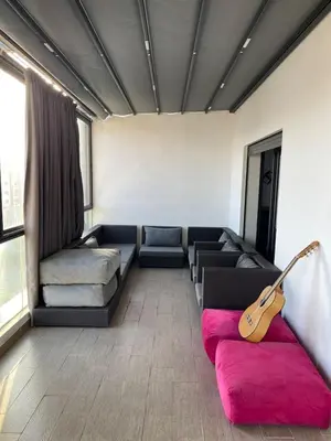 a living room with a couch and a guitar at La perle corniche in Casablanca