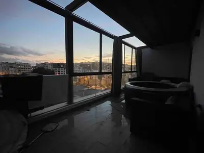 a room with a large window with a view of a city at La perle corniche in Casablanca