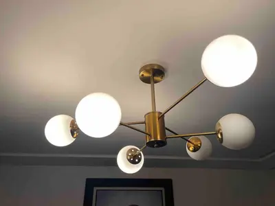 a chandelier with five lights on a ceiling at La perle corniche in Casablanca