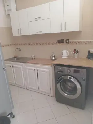 a kitchen with a washing machine and a sink at Appartement HASSANIA in Casablanca