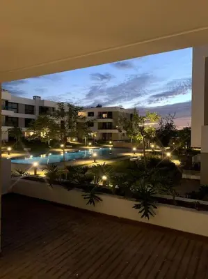 a view of a pool from a balcony of a building at Superbe Appartement Green Town in Oulad Lahsene