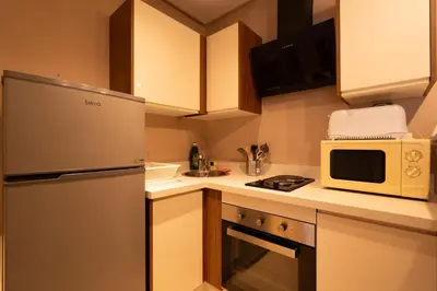 a kitchen with a refrigerator and a microwave at Suite Apt Bourgogne N°2, 2 P in Casablanca