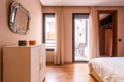 a bedroom with a bed and a mirror on the wall at Suite Apt Bourgogne N°2, 2 P in Casablanca