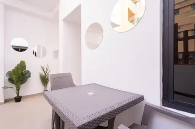 a dining room with a table and a chair at Suite Apt Bourgogne N°2, 2 P in Casablanca