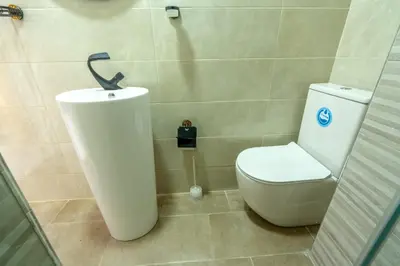 a bathroom with a toilet and a sink at Laura Residence in Bouznika