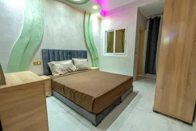 a small bedroom with a bed in a room at Laura Residence in Bouznika