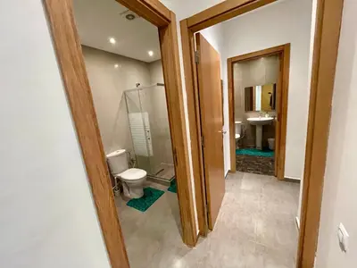 a bathroom with a toilet and a sink at Au Cœur Des Sables D’or - Harhoura in Temara