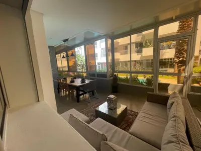 a living room with a couch and a table at Au Cœur Des Sables D’or - Harhoura in Temara