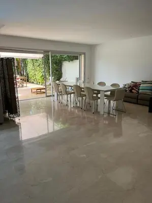 a dining room with a table and chairs at Belle Villa à Bouznika plage - Golf Bouzbay in Bouznika