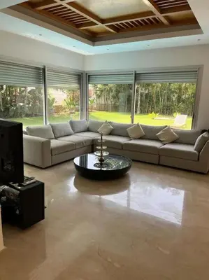 a living room with a couch and a table at Belle Villa à Bouznika plage - Golf Bouzbay in Bouznika