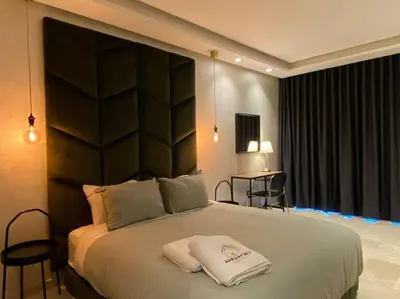 a bedroom with a large bed with a black headboard at Glamorous Habous - By AppartAli in Casablanca
