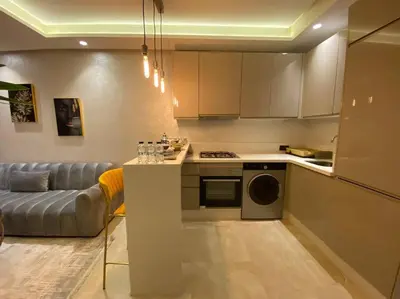 a kitchen with a couch and a table in a room at Glamorous Habous - By AppartAli in Casablanca