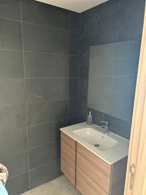 a bathroom with a sink and a mirror at Le Carrousel Appartement in front of the see in Rabat