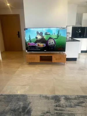 a flat screen tv sitting on top of a wooden table at Le Carrousel Appartement in front of the see in Rabat