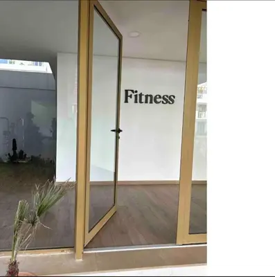 a glass door with the word fitness written on it at Le Carrousel Appartement in front of the see in Rabat