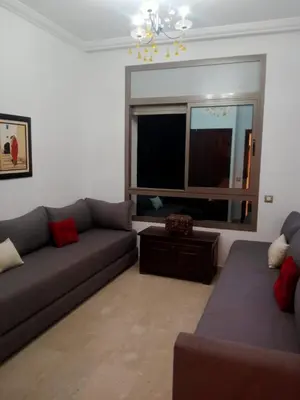 a living room with two couches and a television at Bel appartement à skhirat plage et à 20 mn de Rabat in Skhirat