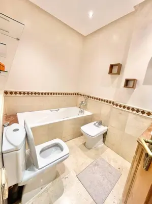 a bathroom with a toilet and a bidet and a sink at Appartement Cozy au Triangle d’or in Casablanca