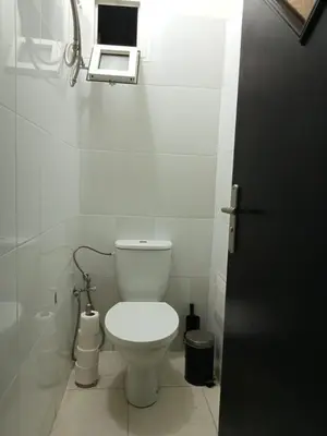 a bathroom with a toilet and a laptop on the wall at Maison indépendante 100m2 à Témara centre in Temara